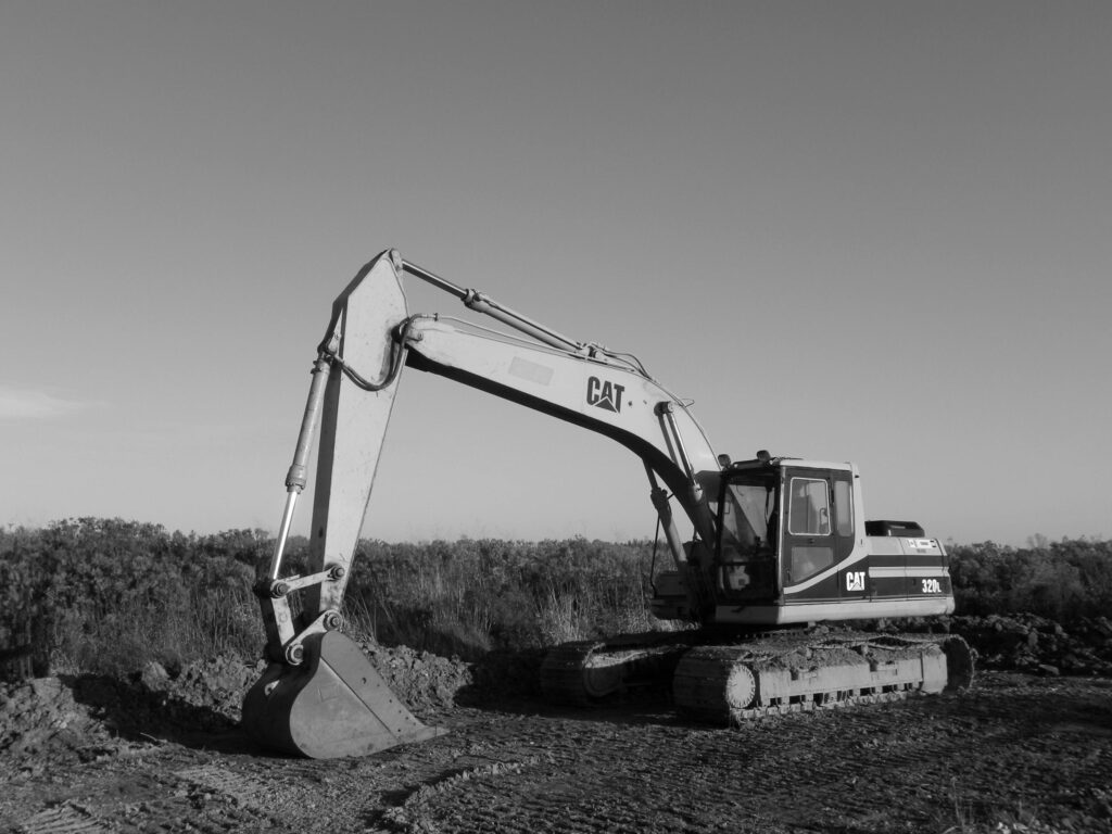 Monochrome image of an excavator at a construction site, ideal for industry themes.